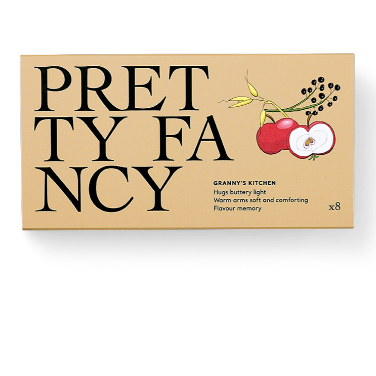 A box of Pretty Fancy brand chocolates with a vintage design, featuring an apple and leaves motif, suggestive of traditional, old-fashioned recipes.