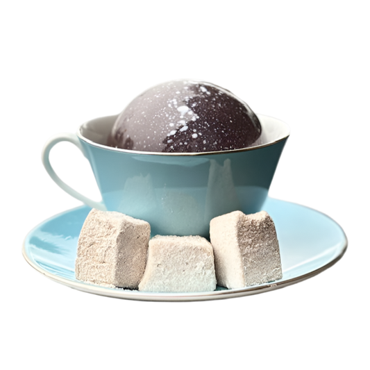 Teacup with a dark hot chocolate bomb dessert and marshmallows on a white background